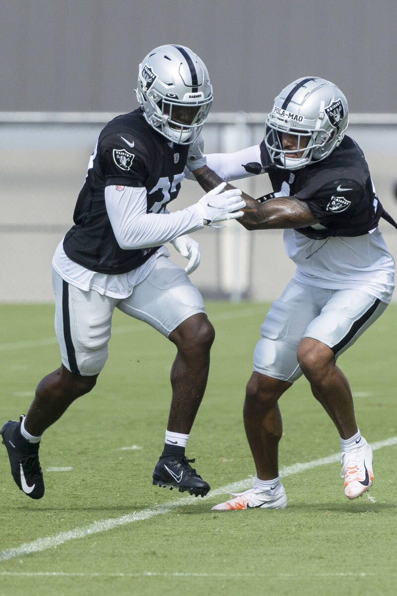 Raiders safeties Tyree Gillespie (37) and Isaiah Pola'mau (40) work through a drill during the ...