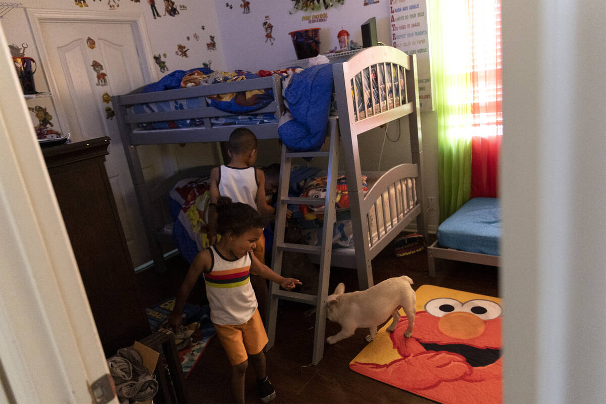 Xzavion Christmas, 4, front, and Mason Christmas, 7, play in their room at their home on Friday ...