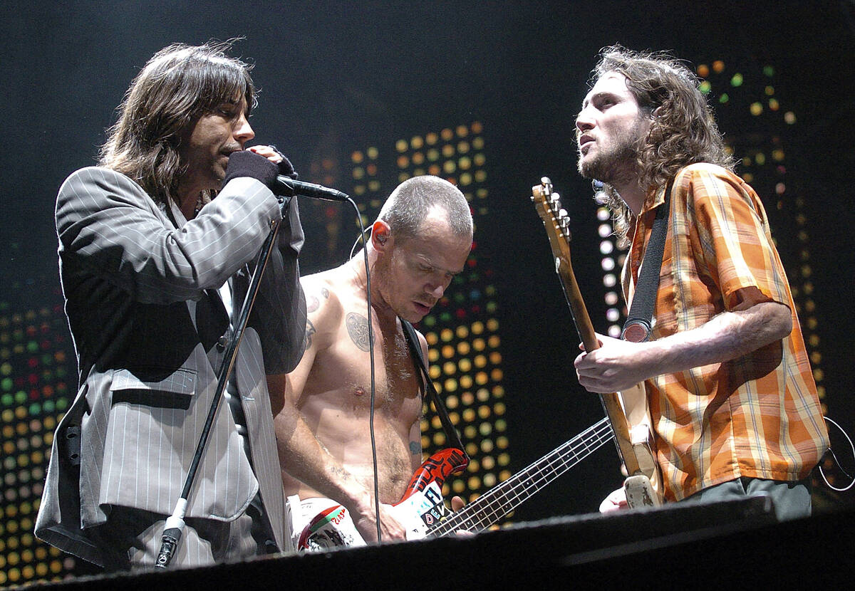 Red Hot Chili Peppers singer Anthony Kiedis, left, bassist Flea, center, guitarist John Frusci ...
