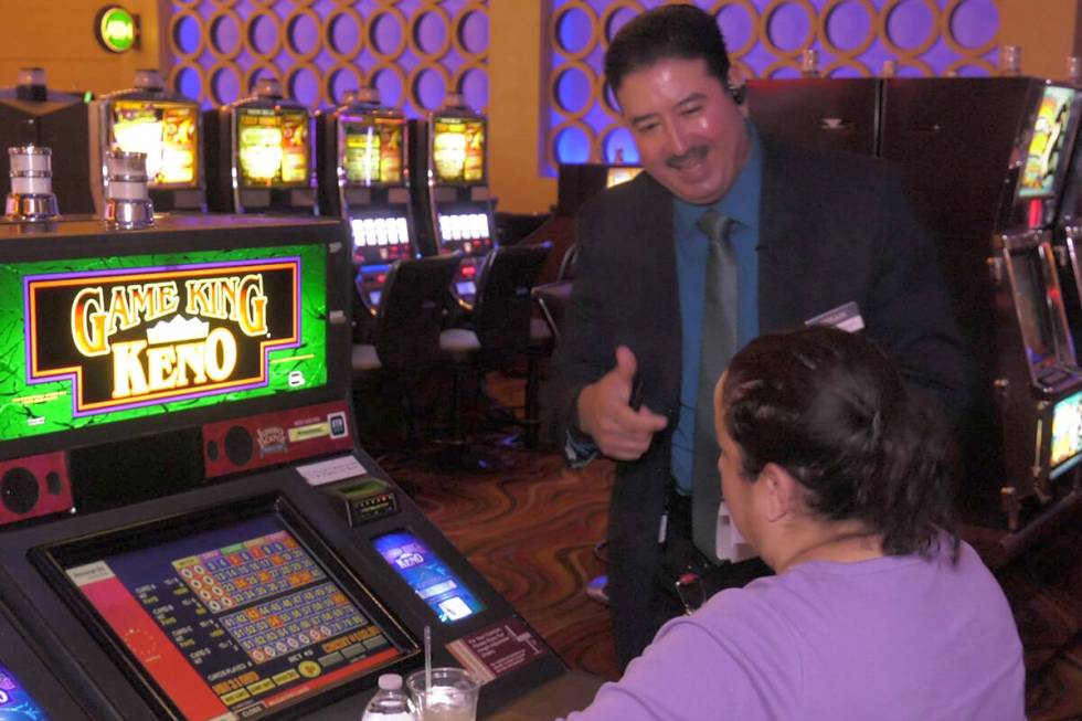 Red Rock Casino guest service specialist Ephrain Trillo congratulates player after she won $1,6 ...