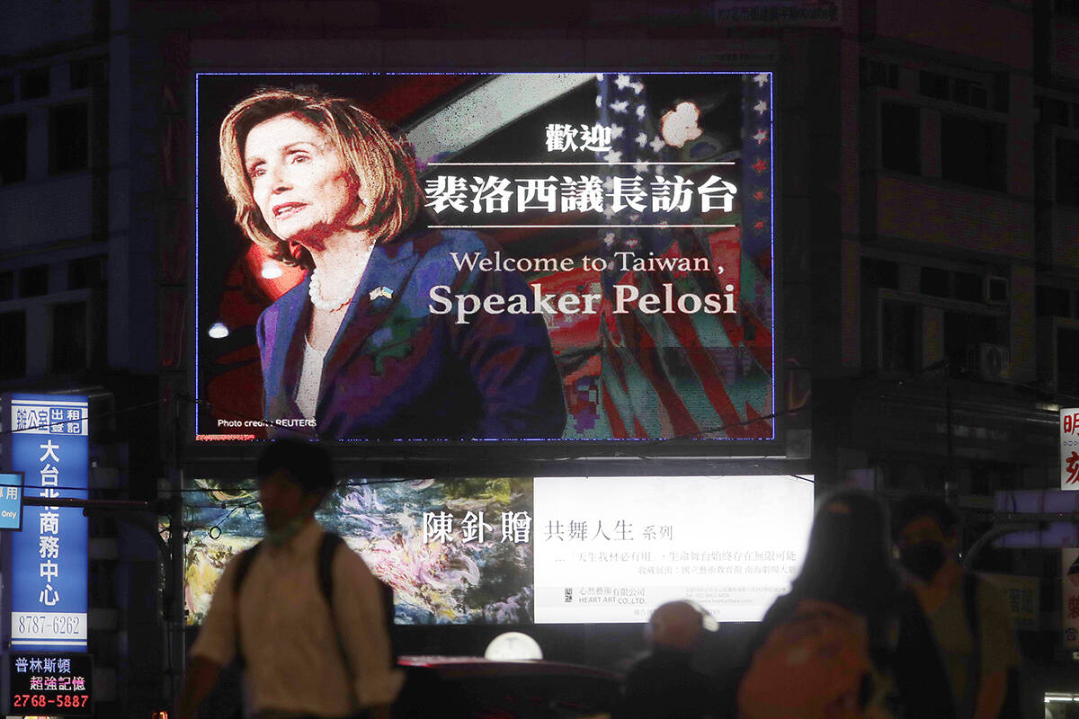 People walk past a billboard welcoming U.S. House Speaker Nancy Pelosi, in Taipei, Taiwan, Tues ...