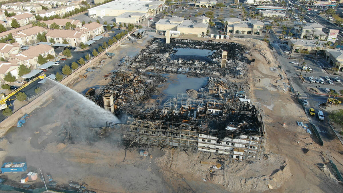 An aerial view of the damage after an overnight fire at an under-construction apartment complex ...