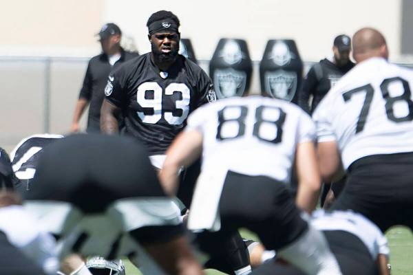 Raiders defensive tackle Neil Farrell, Jr. (93) stretches during the team’s mandatory mi ...