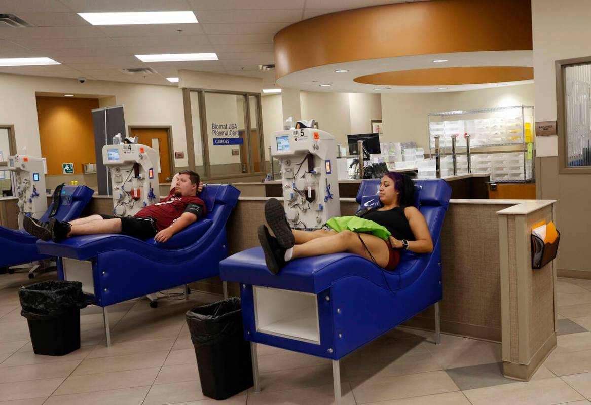 Mark Conoly of Las Vegas and Tracy Hernandez of Las Vegas donate their plasma at the Grifols Bi ...