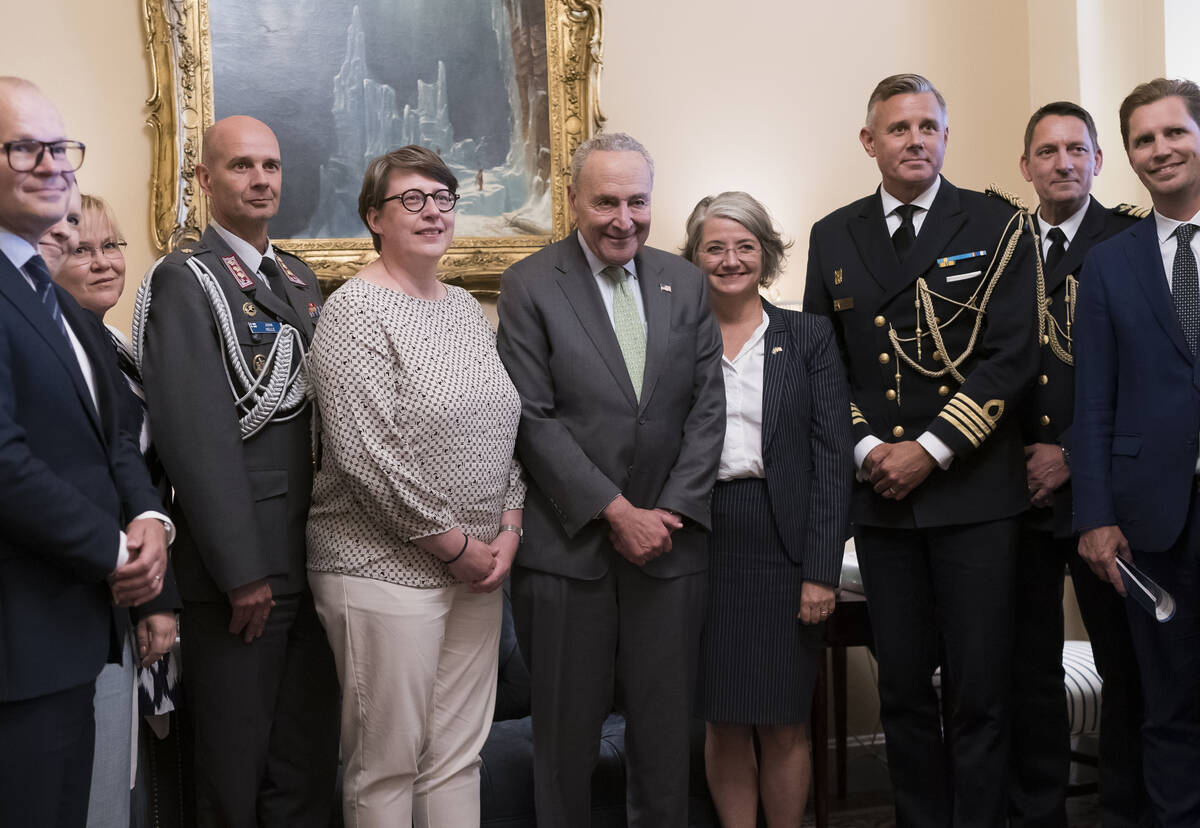 Senate Majority Leader Chuck Schumer, D-N.Y., center, is flanked by Paivi Nevala, minister coun ...