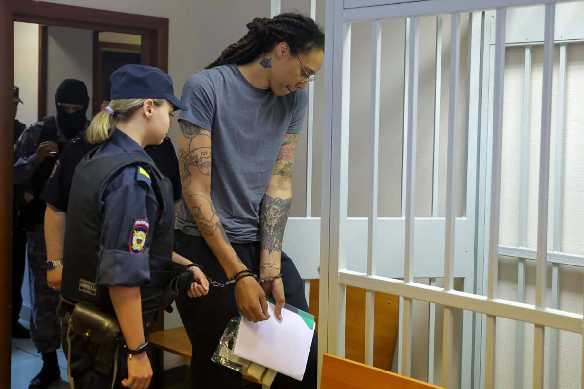 WNBA star and two-time Olympic gold medalist Brittney Griner, right, enters a cage in a courtro ...
