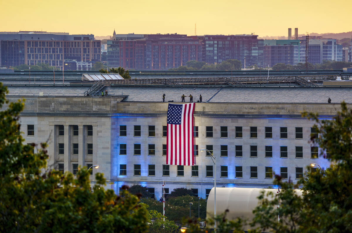 An American flag is unfurled at the Pentagon in Washington, Saturday, Sept. 11, 2021, at sunris ...