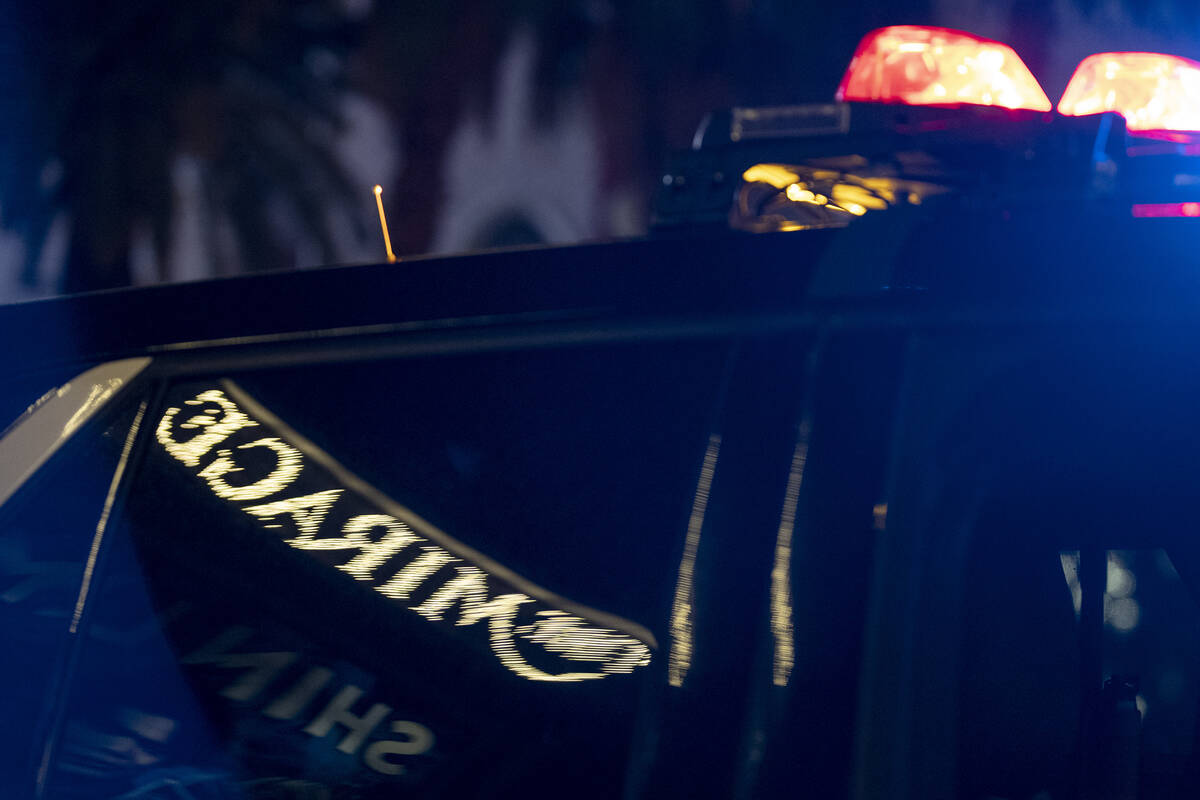 The Mirage sign is reflected in a Metropolitan police vehicle while police respond to a fatal s ...