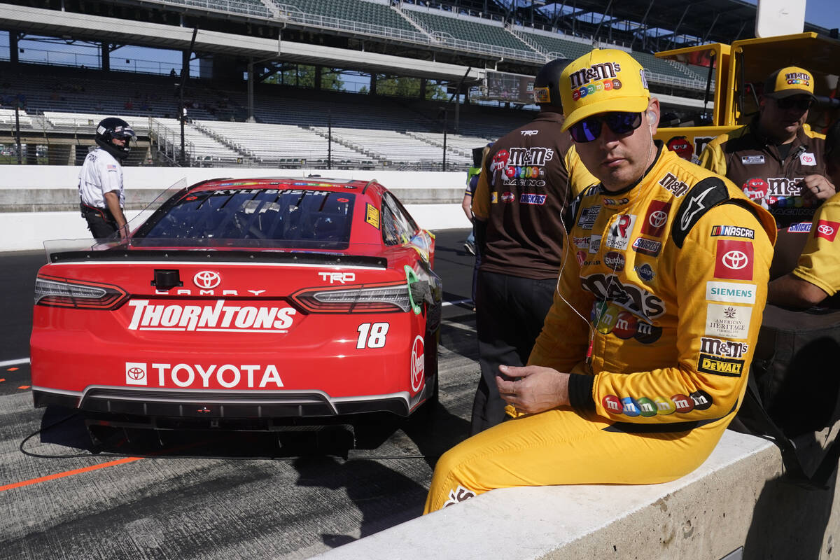 Kyle Busch sits on pit wall during qualifications for the NASCAR Cup Series auto race at Indian ...