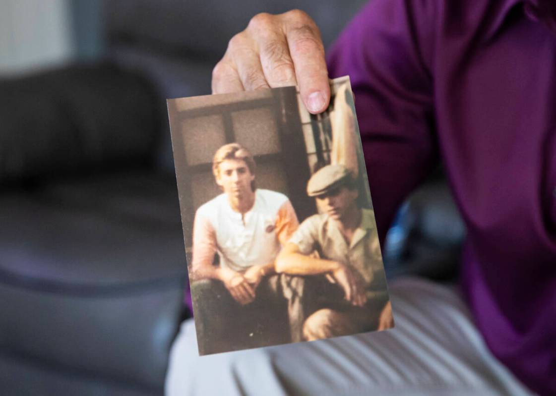 Michael DiVicino, former inmate and author, shows a photo of himself, left, with a relative on ...