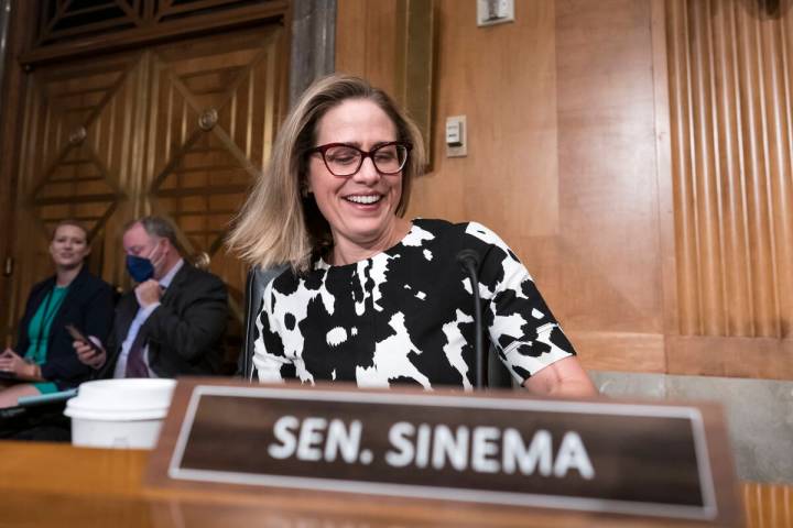 FILE - Sen. Kyrsten Sinema, D-Ariz., arrives for a meeting of the Senate Homeland Security Comm ...