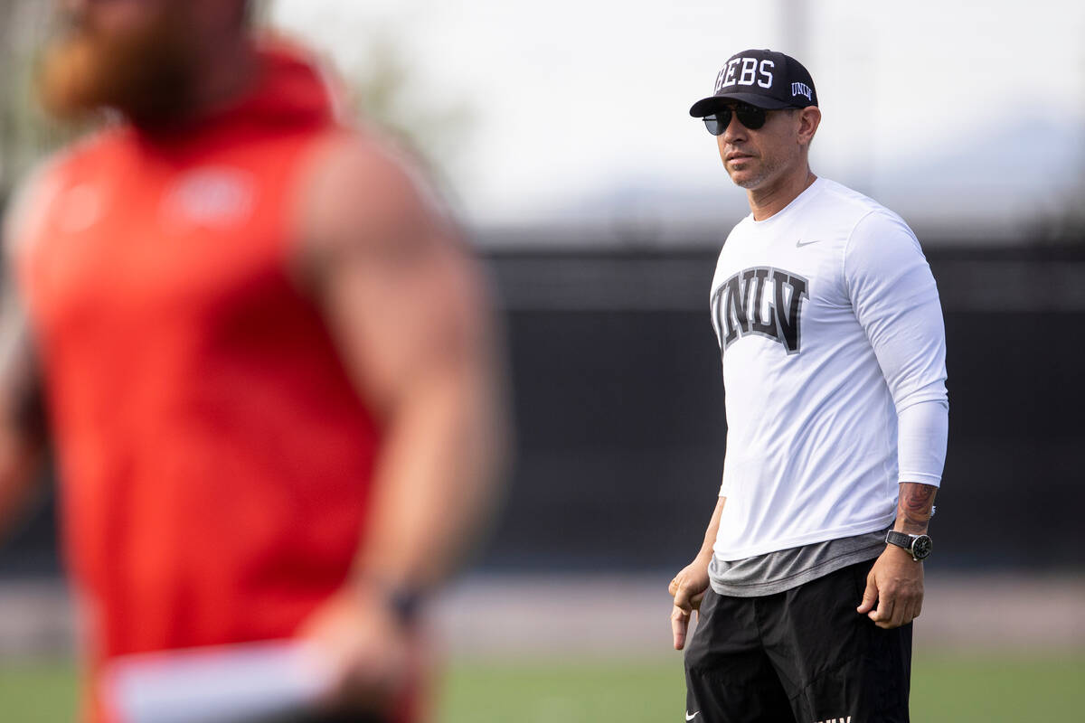 UNLV football coach Marcus Arroyo watches his players run drills during a team practice at UNLV ...