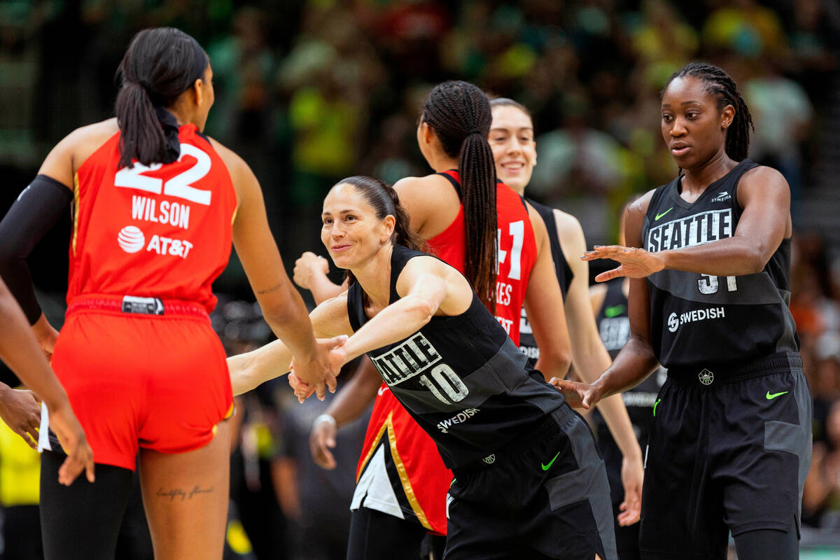 Seattle Storm's Sue Bird greets Las Vegas Aces' A'ja Wilson (22) prior to the start of a WNBA b ...