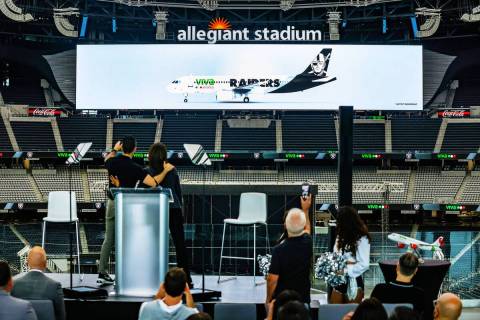 The crowd watches the screen with a plane showing the new partnership between the new official ...