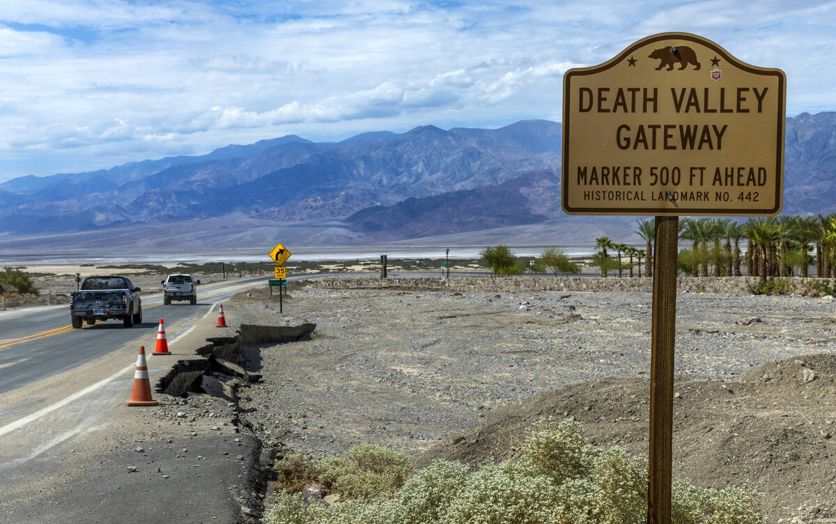Vehicles pass road damage on State Route 190 adjacent to The Inn at Death Valley at the nationa ...