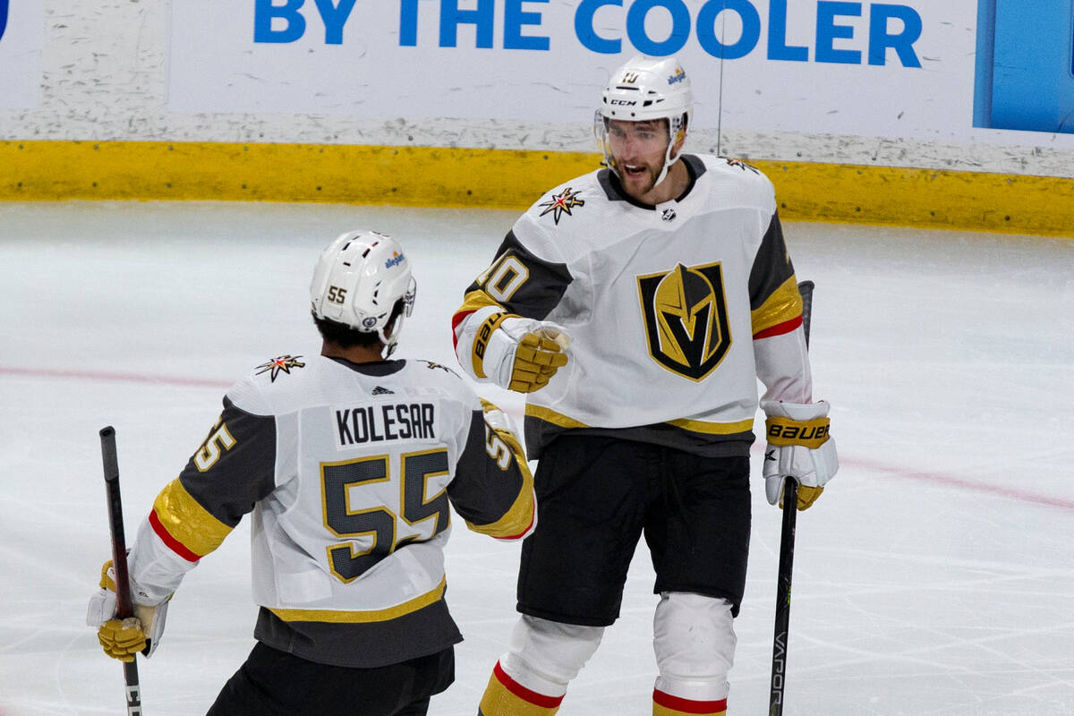 Vegas Golden Knights center Nicolas Roy (10) celebrates his goal with Keegan Kolesar (55) in th ...