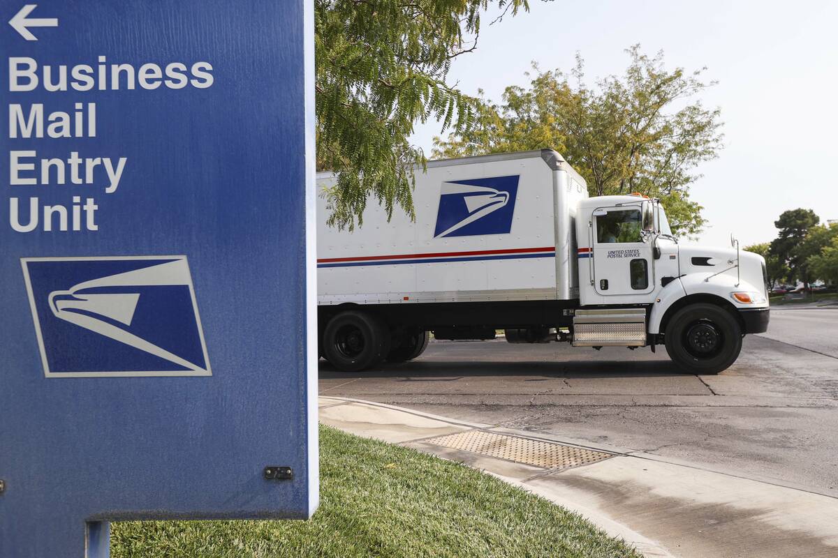 A truck departs from the U.S. Postal Service center at 1001 E. Sunset Road in Las Vegas on Aug. ...