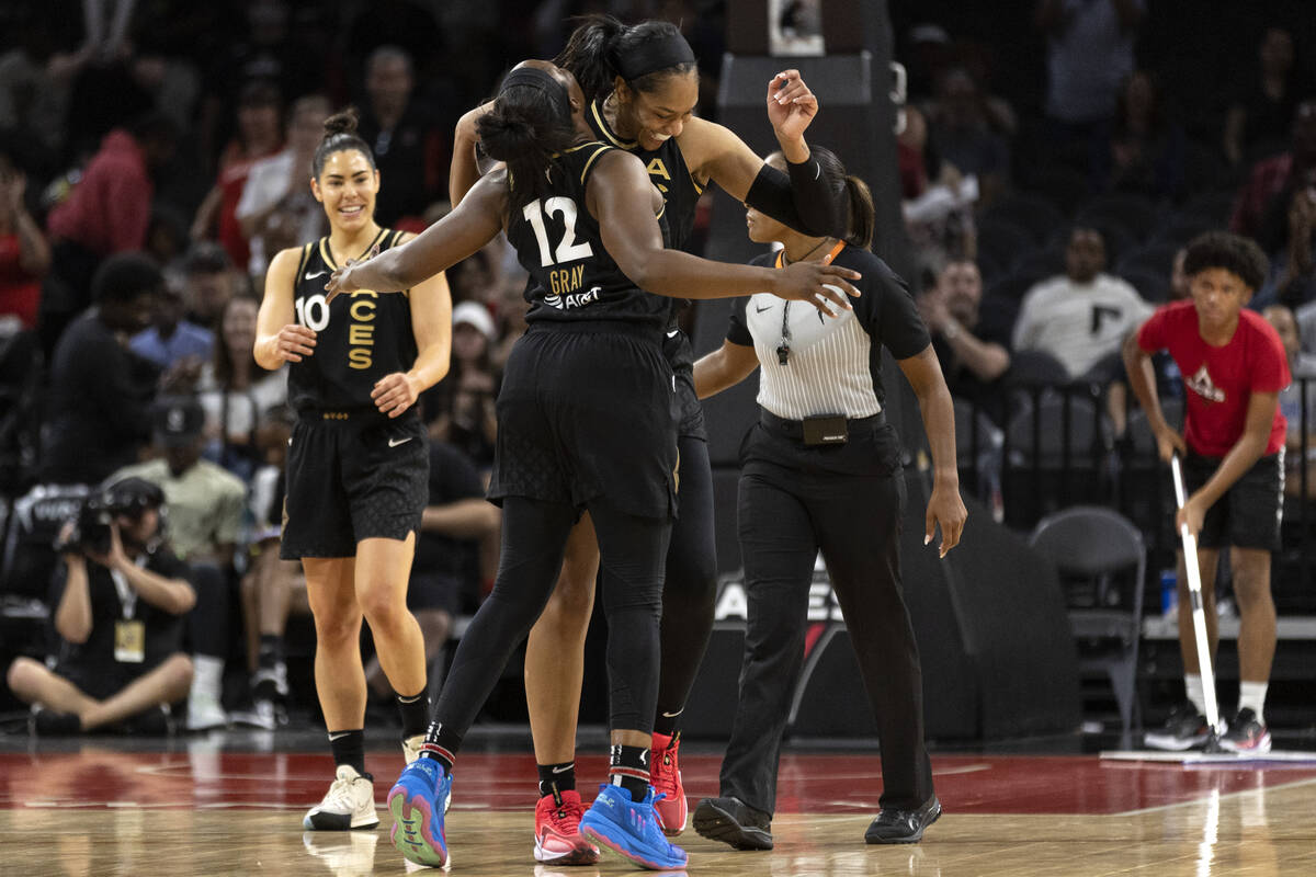 Las Vegas Aces forward A'ja Wilson (22) and guard Chelsea Gray (12) celebrate a foul called on ...