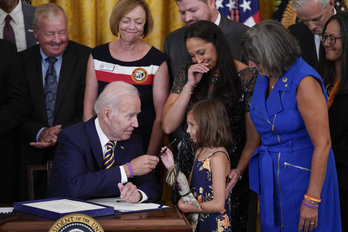 President Joe Biden gives the pen he used to sign the "PACT Act of 2022" to Brielle R ...