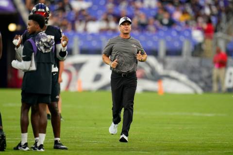 Baltimore Ravens head coach John Harbaugh runs to a station as his team works out during the te ...