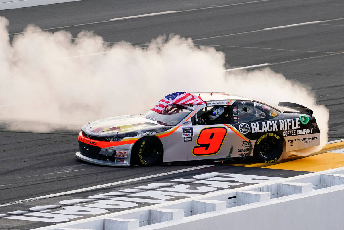 Noah Gragson (9) smokes his tires after he won the NASCAR Xfinity Series auto race at Pocono Ra ...