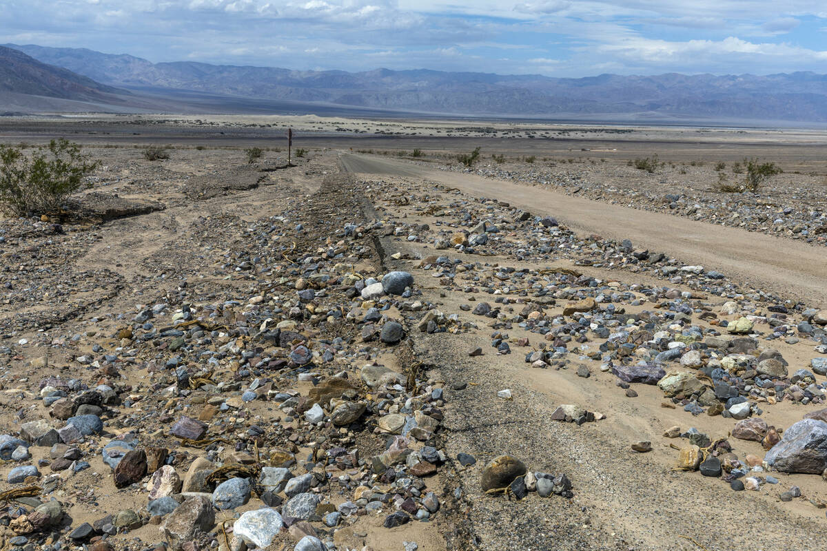 Rocks and mud cover sections of Daylight Pass Road temporarily closed due to road damage within ...