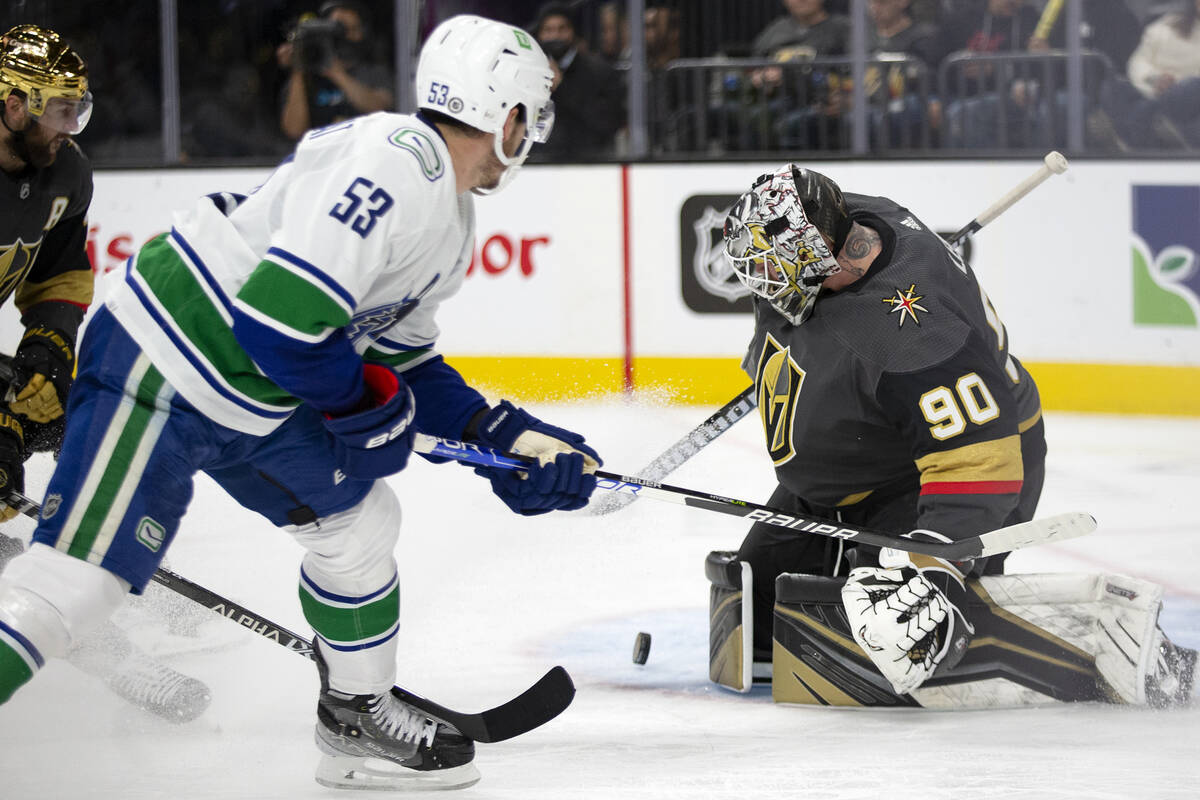 Golden Knights goaltender Robin Lehner (90) saves a shot by Canucks center Bo Horvat (53) durin ...