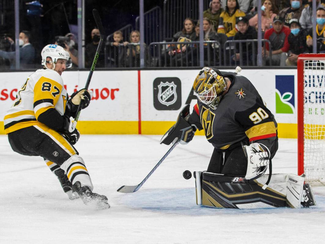 Golden Knights goaltender Robin Lehner (90) makes a save against Pittsburgh Penguins center Sid ...