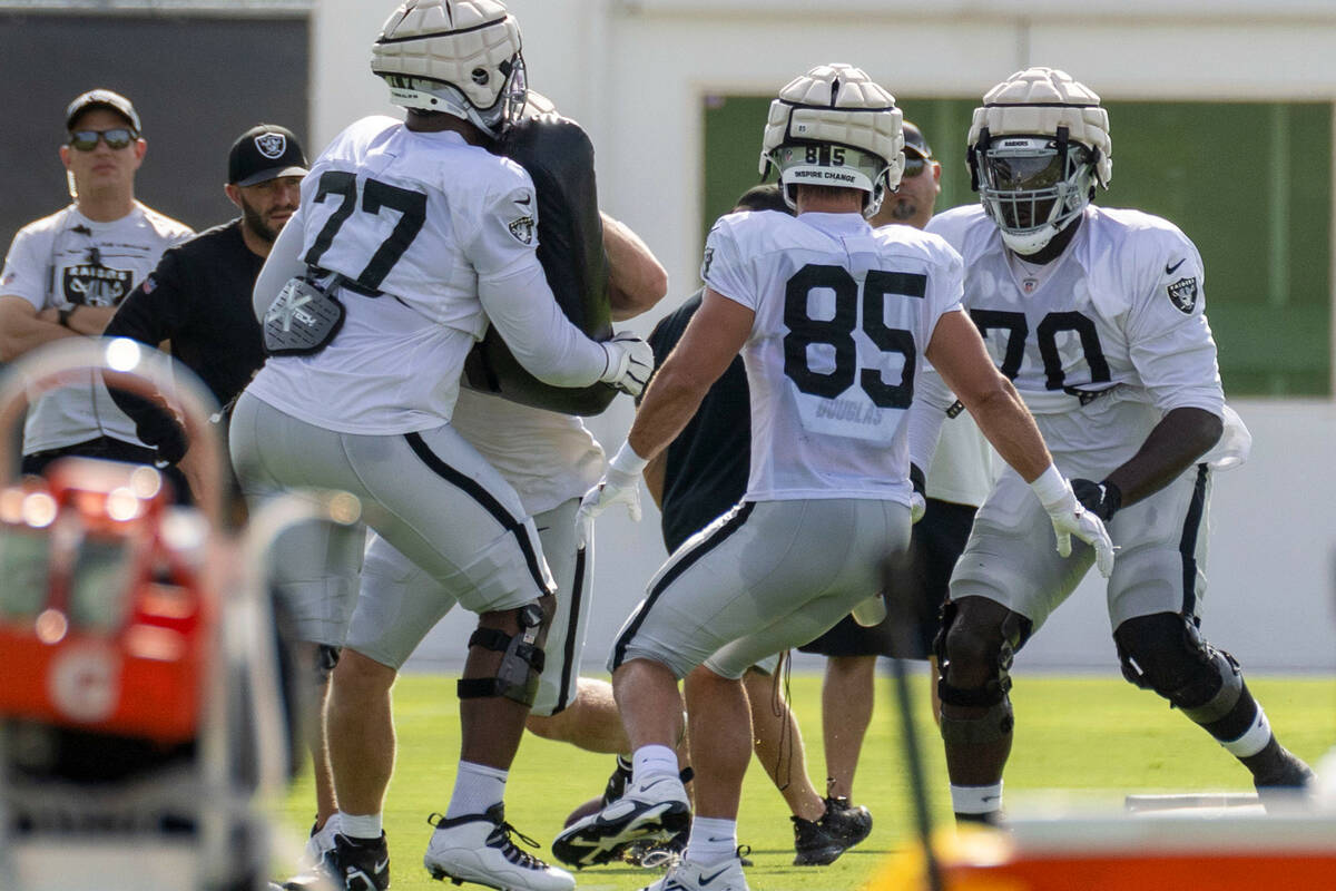 Raiders offensive tackle Thayer Munford Jr. (77) drills with offensive tackle Alex Leatherwood ...