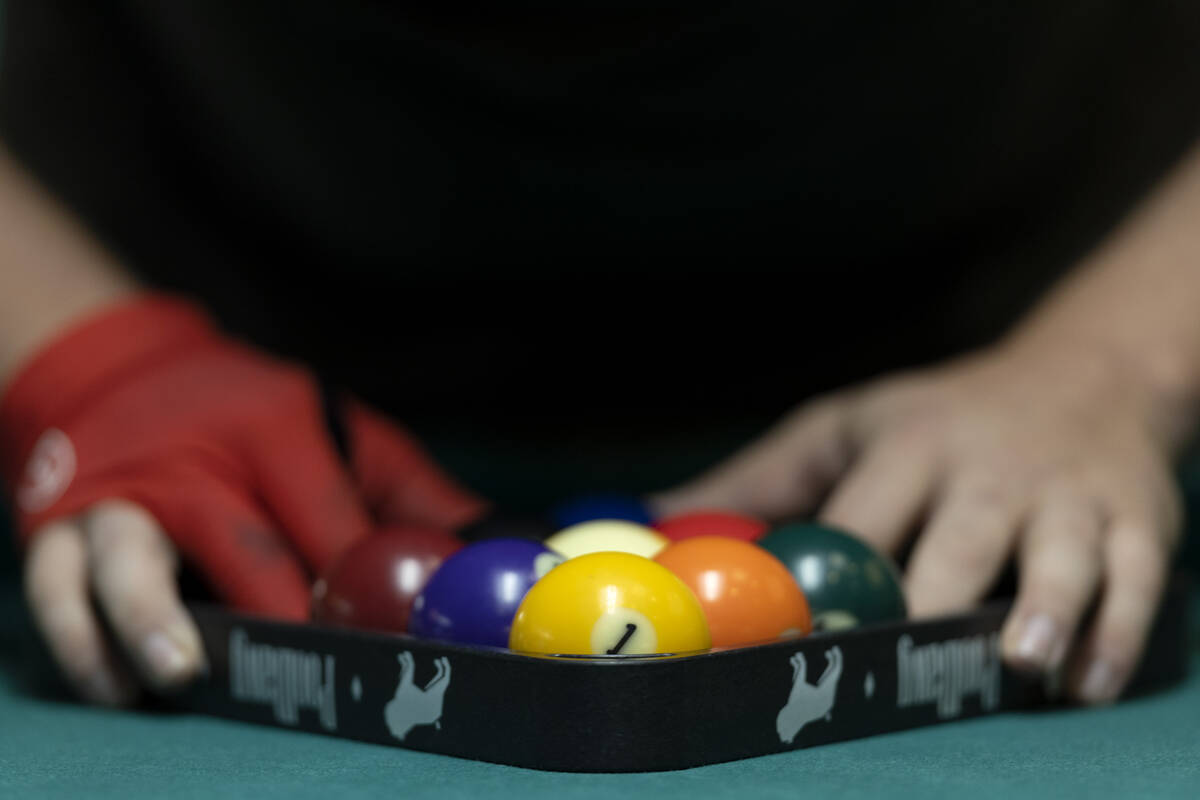A competitor racks up balls during the American Poolplayers Association World Pool Championship ...