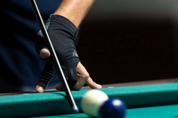 A competitor strikes the cue ball during the American Poolplayers Association World Pool Champi ...