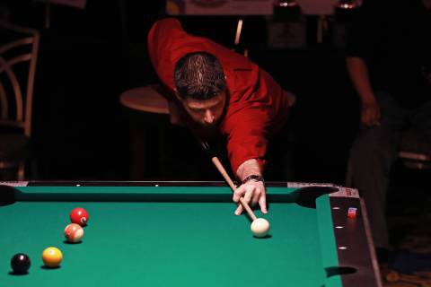 Aaron Greenwood, of New York, competes in the American Poolplayers Association 8-Ball Classic a ...