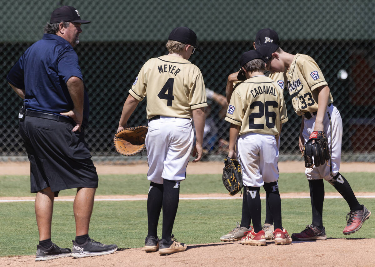 Paseo Verde's head coach Bill Senne discusses with his players during the Little League Basebal ...