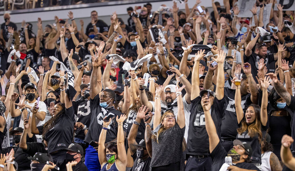 Fans do the wave during the third quarter of the Raiders home opening pre-season NFL football g ...