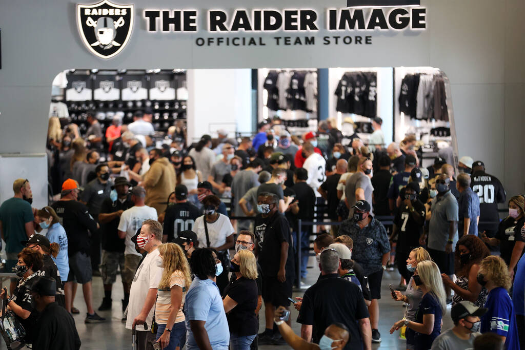 Fans walks the concourse before the start of a NFL preseason game between the Las Vegas Raiders ...