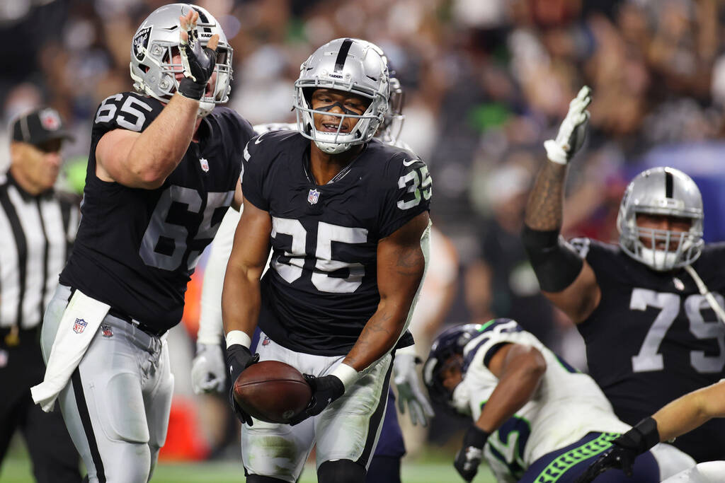 Las Vegas Raiders running back B.J. Emmons (35) reacts after a rushing touchdown, with center J ...
