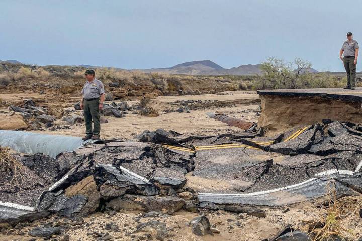 Two rangers examine road damage at Mohave National Preserve. (National Park Service)