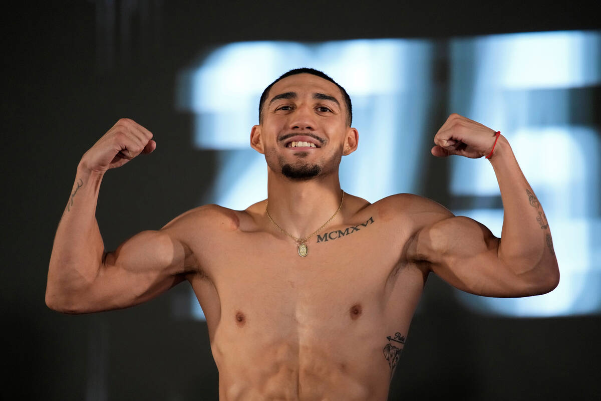 Teofimo Lopez poses on the scale during a weigh-in for a junior welterweight boxing match, Frid ...