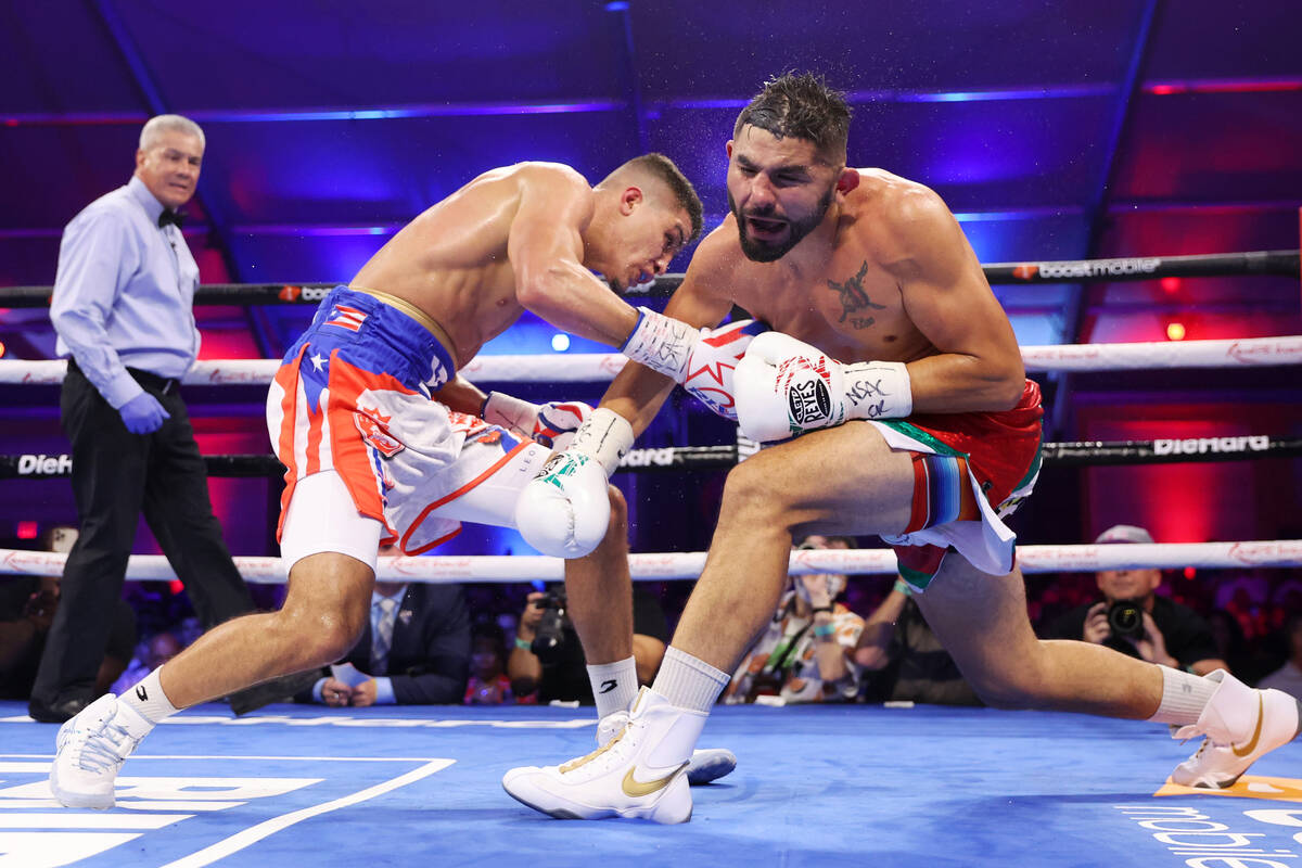 Xander Zayas, left, connects a punch against Elias Espadas in the third round of a middleweight ...