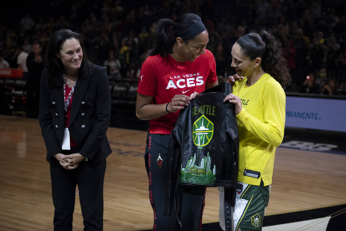 Jennifer Azzi, left, and A'ja Wilson present Sue Bird with a custom leather jacket before the f ...