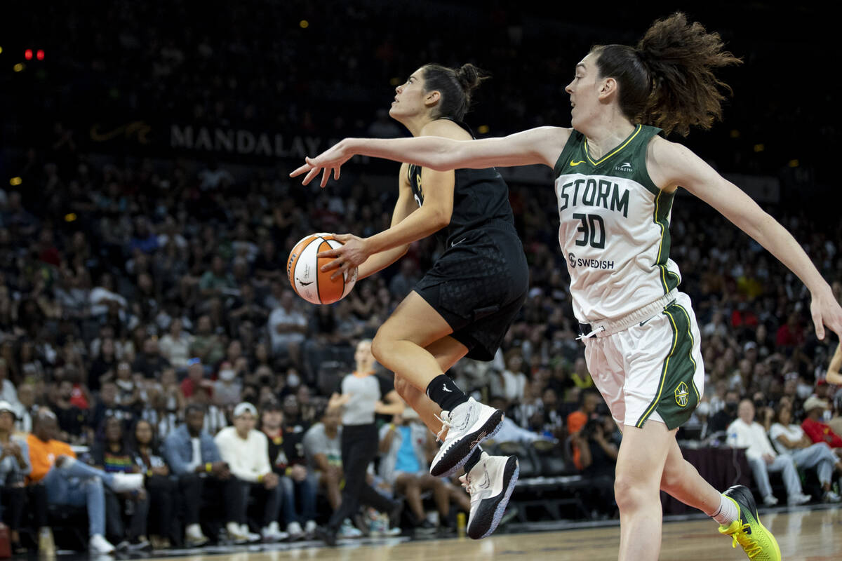 Aces guard Kelsey Plum (10) goes up for a shot past Storm forward Breanna Stewart (30) as the L ...