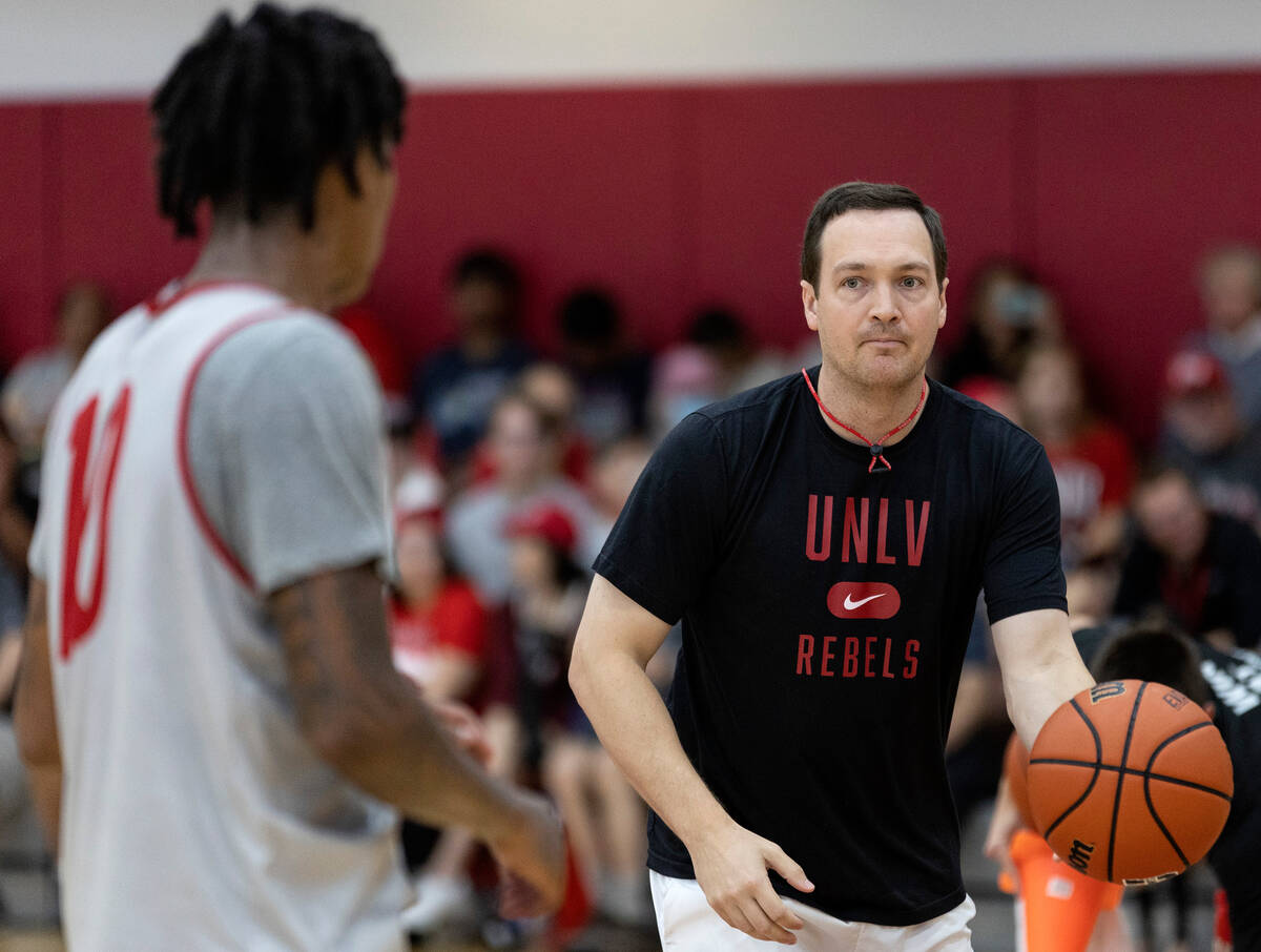 UNLV Rebels head coach Kevin Kruger passes the ball to guard Keshon Gilbert (10) during UNLV me ...