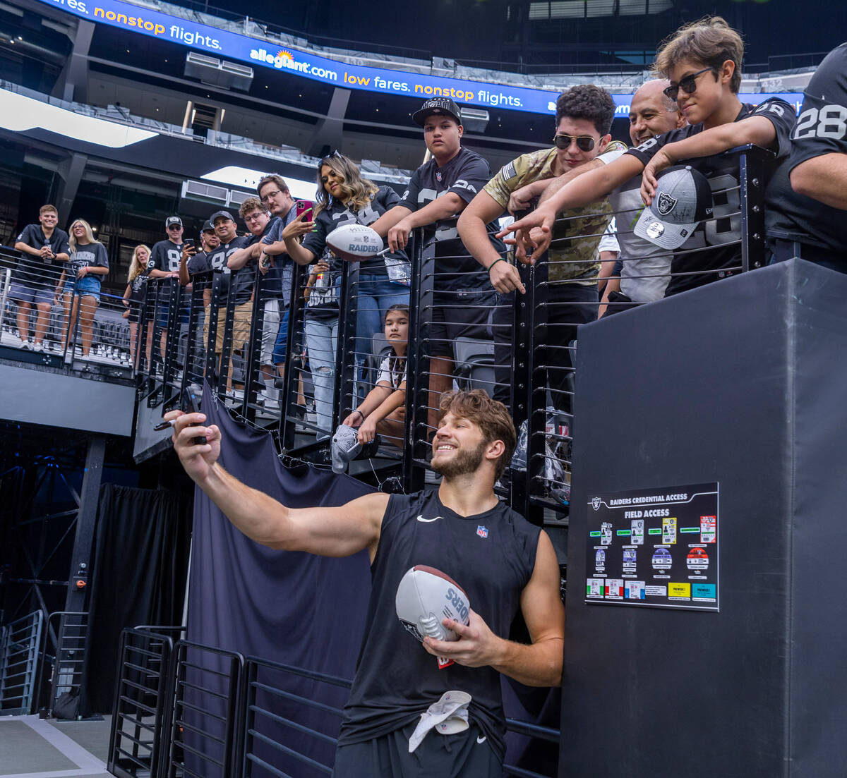 Raiders tight end Foster Moreau (87) takes a selfie with fans before the Raiders versus Vikings ...