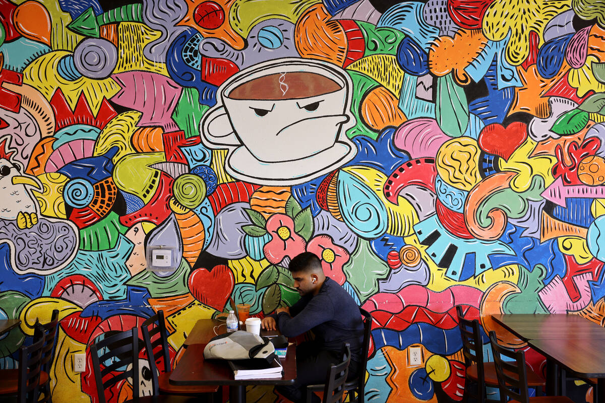 Divyansh Sharma drinks coffee while studying at Grouchy John's Coffee on South Maryland Parkway ...