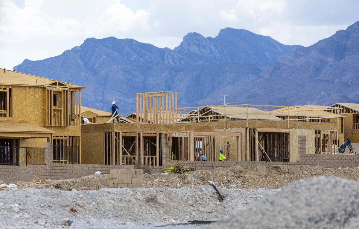 Workers complete framing and walls on new home construction about Skye Canyon on Wednesday, Jul ...