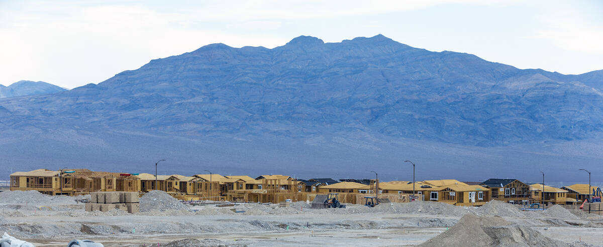 Workers complete framing and walls on new home construction about Skye Canyon on Wednesday, Jul ...