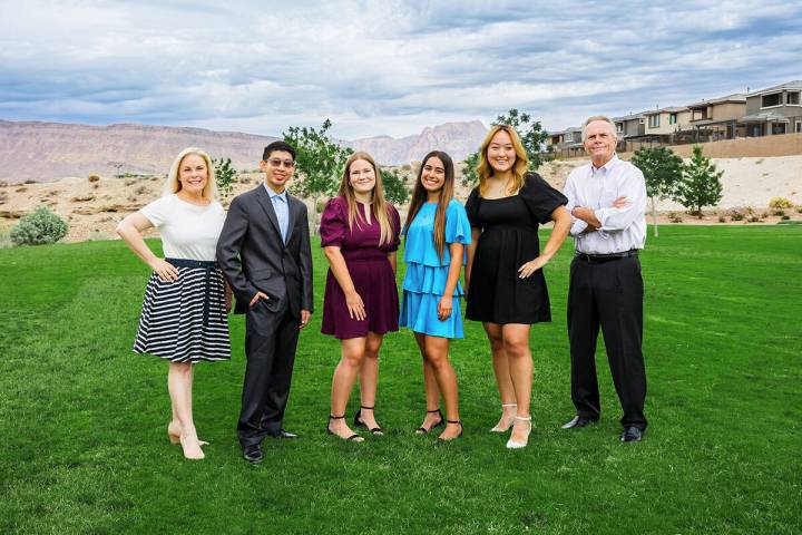 Flanked by The Howard Hughes Corp. executives, Danielle Bisterfeldt, left, and Randy Ecklund, r ...