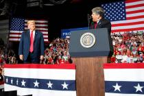 Donald Trump listens Fox News' Sean Hannity speak during a rally at Show Me Center, Monday, Nov ...