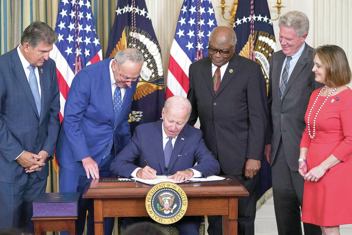 President Joe Biden signs the Democrats' landmark climate change and health care bill in the St ...