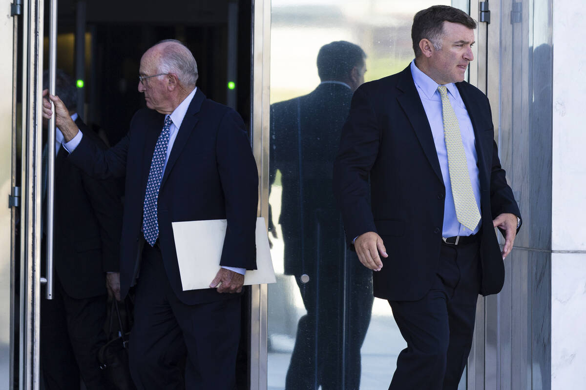 FBI agent Scott Carpenter, 40, right, leaves the Lloyd George U.S. Courthouse after his sentenc ...